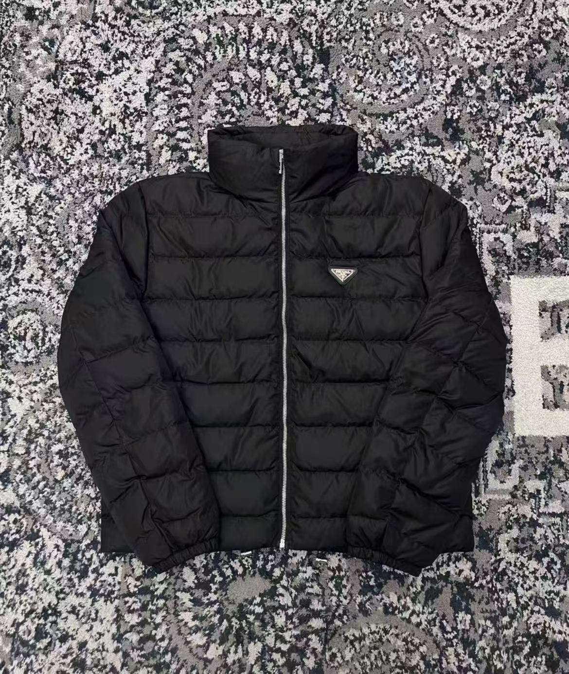 Prada metal triangle logo down jacket in black